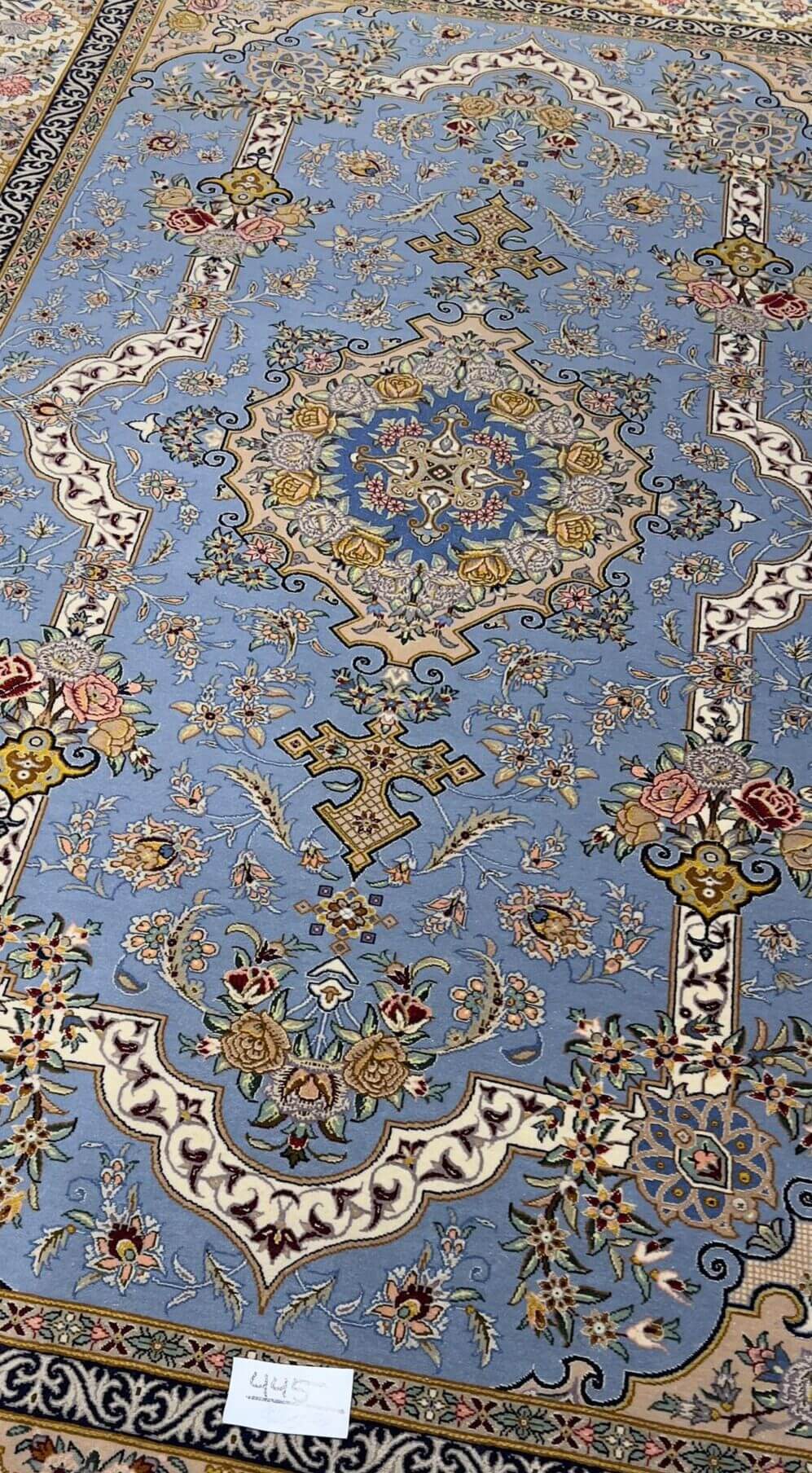 "Luxurious wool and silk Isfahan rug featuring a detailed medallion and floral motifs."